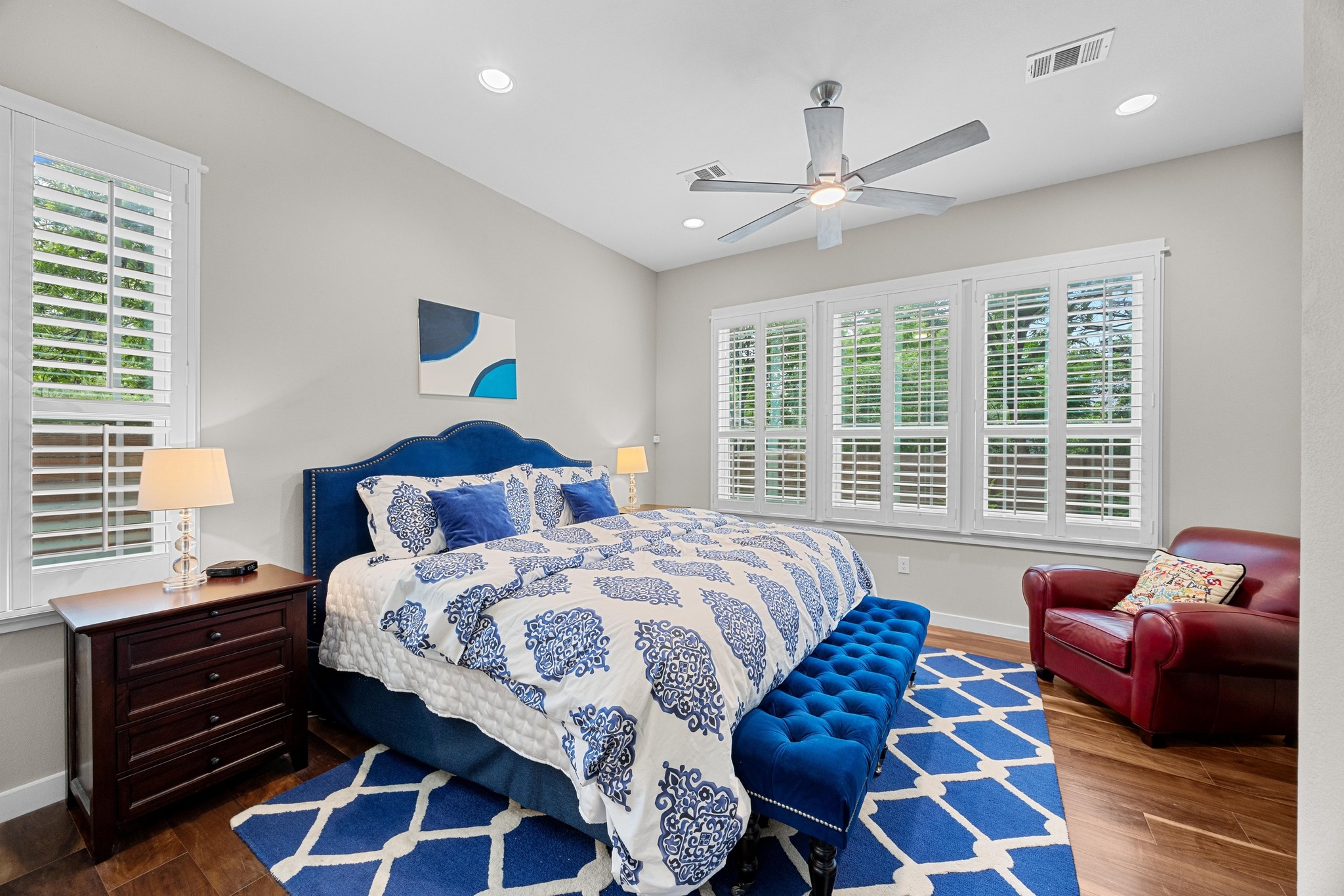 3907 Becker Avenue Austin, TX 78751 - Photo 16 of 37 Primary bedroom featuring custom shutters, wood floors, ceiling fan, recessed lighting, high ceilings and plenty of natural light.