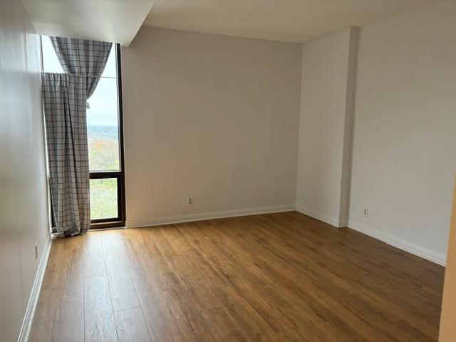 145 15th Street Northeast, Unit 1007 Atlanta, GA 30361 - Photo 11 of 14 a view of a room with wooden floor and window