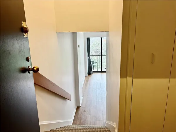 a view of a hallway with wooden floor