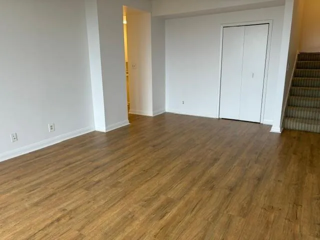 a view of a room with wooden floor and window