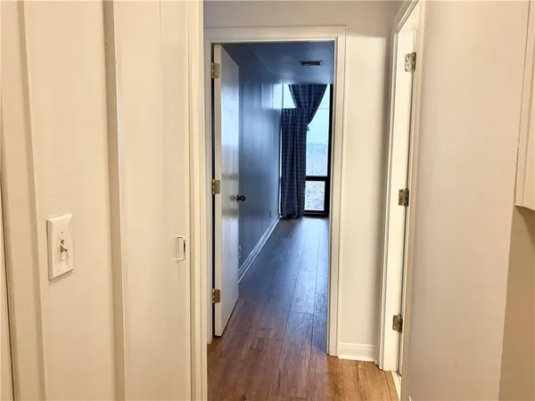 a view of a room with wooden floor and window