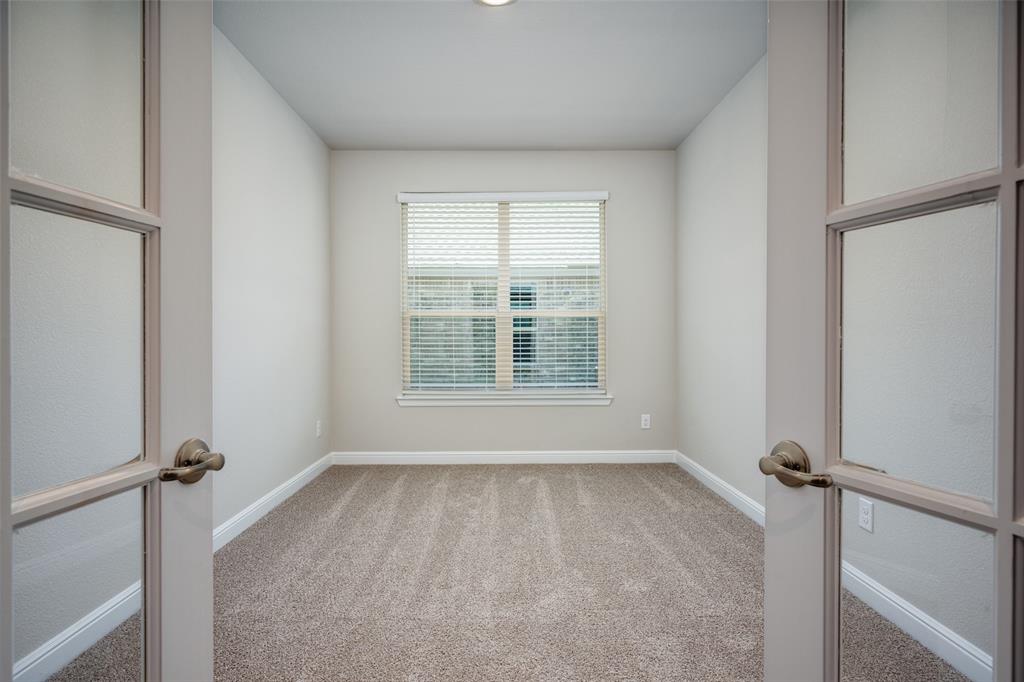 5231 Meadow Lane Krum, TX 76249 - Photo 5 of 17 Room featuring French doors with frosted glass panels, neutral carpet, white baseboards, a single window with blinds, and light-colored walls