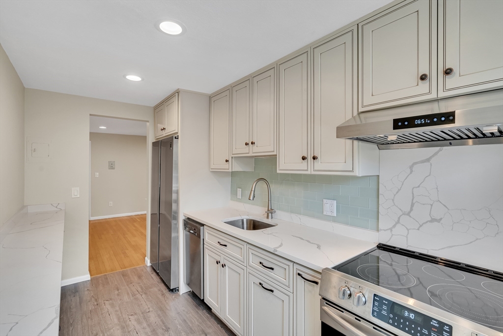 8 Colonial Village Drive, Unit 9 Arlington, MA 02474 - Photo 1 of 31 a kitchen with a sink and cabinets