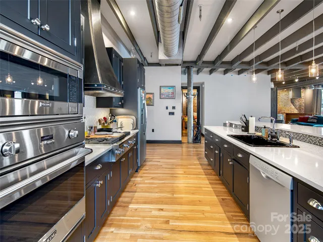 a large kitchen with stainless steel appliances granite countertop lots of counter top space