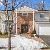 a view of a house with snow on the road