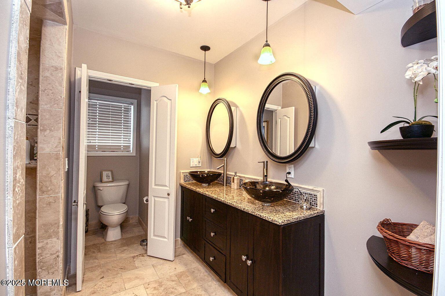 30 Stockton Avenue Seaside Park, NJ 08752 - Photo 14 of 16 a bathroom with a granite countertop toilet a sink and a mirror