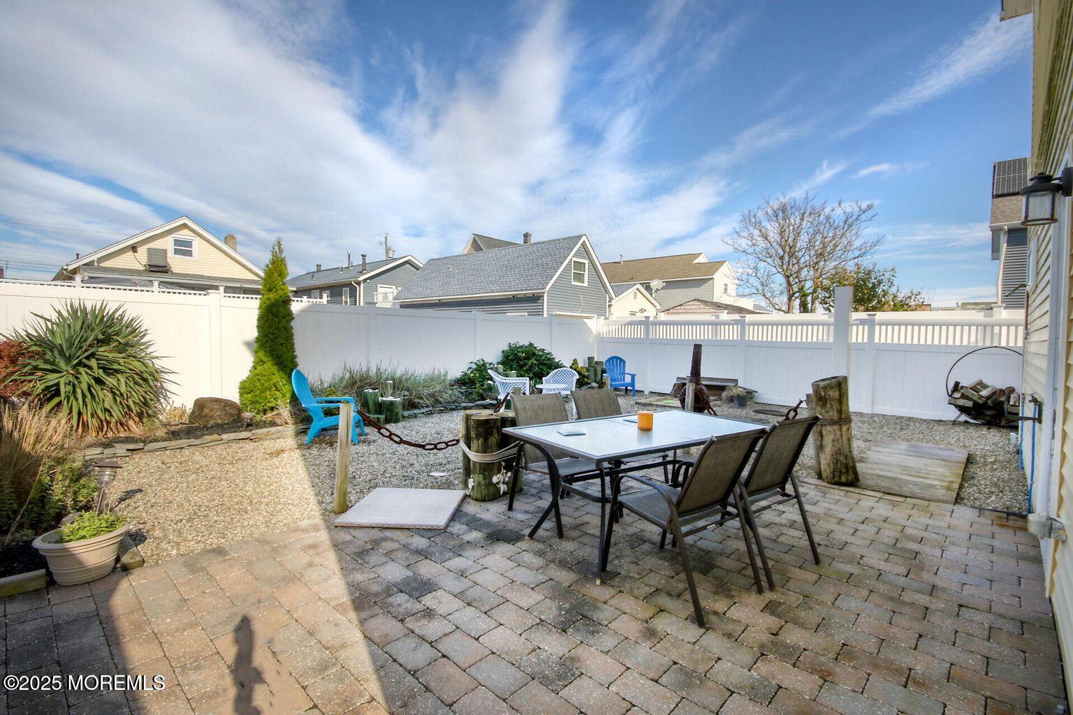 30 Stockton Avenue Seaside Park, NJ 08752 - Photo 16 of 16 a view of a patio with table and chairs and potted plants