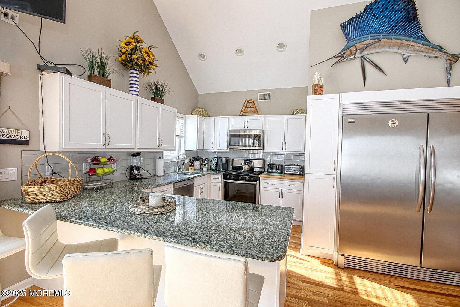 30 Stockton Avenue Seaside Park, NJ 08752 - Photo 4 of 16 a kitchen with sink a refrigerator and cabinets