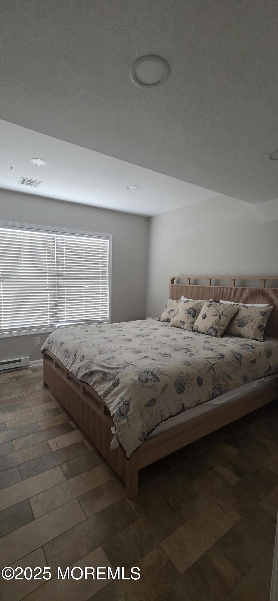 30 Stockton Avenue Seaside Park, NJ 08752 - Photo 7 of 16 a bedroom with a bed wooden floor and window