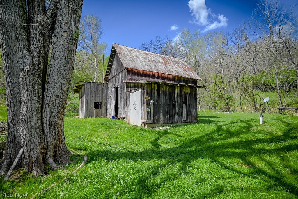 1547 Providence Road Elizabeth, WV 26143 - Photo 29 of 32 Rustic wood-sided outbuilding with a corrugated metal roof