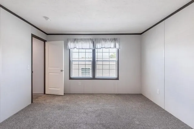 an empty room with a empty space and windows