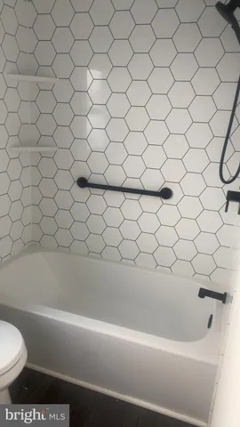 a bathroom with a bathtub and toilet