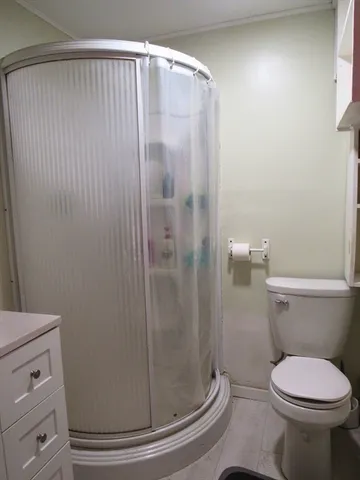 a bathroom with a toilet and a shower