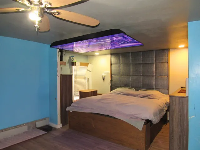 a bedroom with a bed and a chandelier