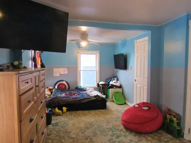 a bedroom with furniture and a flat screen tv