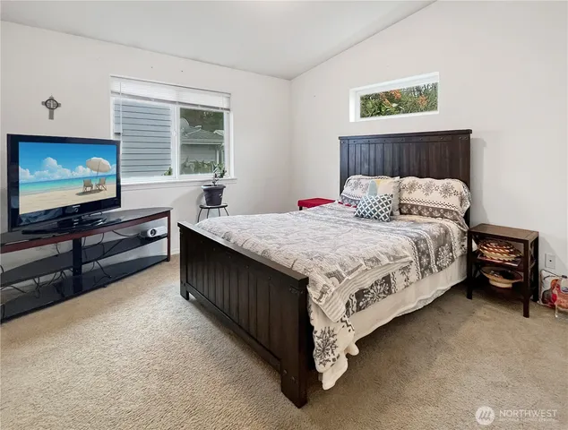 a bedroom with a bed and a flat screen tv