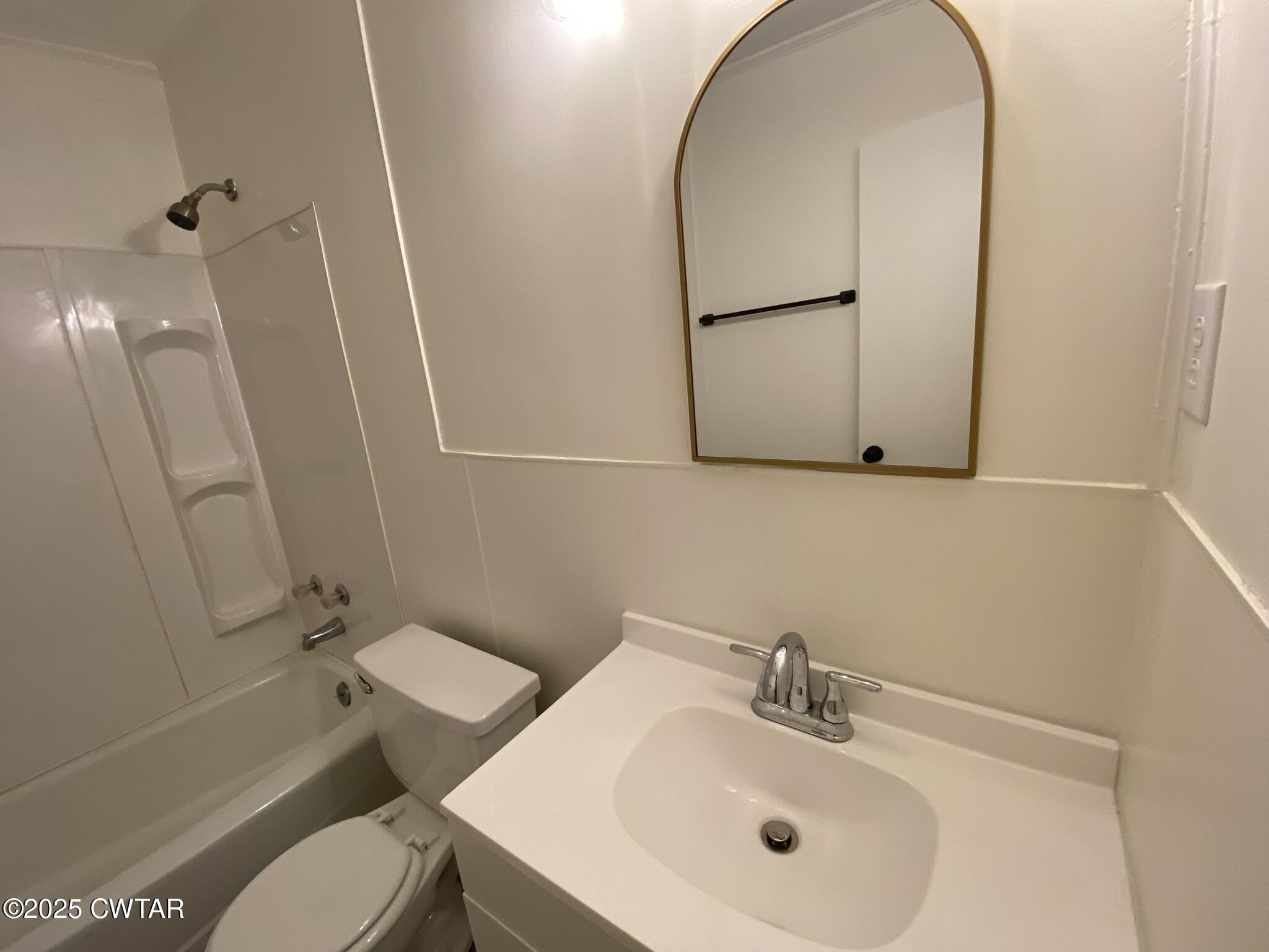234 Tulip Street Henderson, TN 38340 - Photo 13 of 14 a bathroom with a sink mirror and toilet