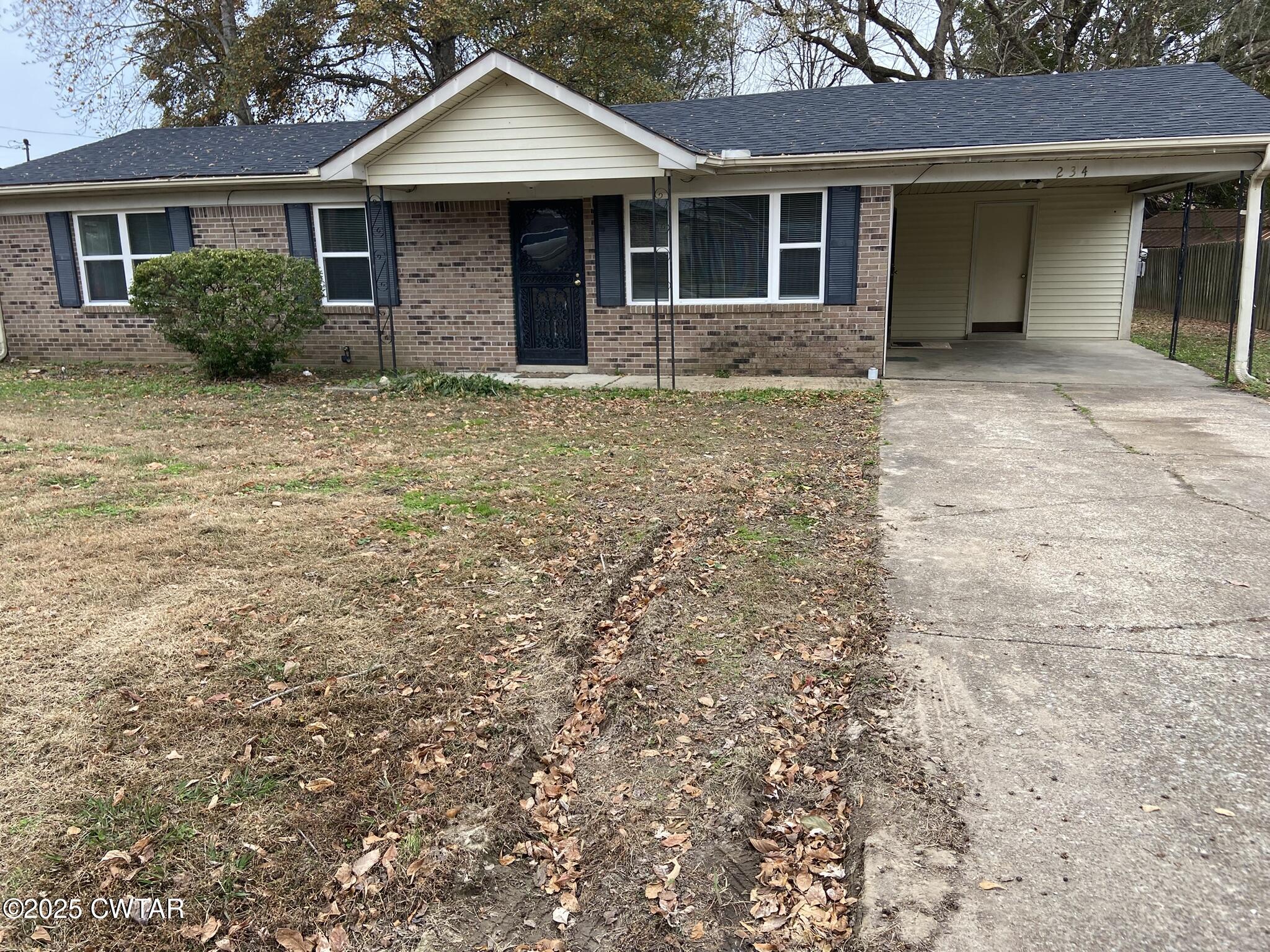 234 Tulip Street Henderson, TN 38340 - Photo 3 of 14 a front view of a house with yard patio and glass windows