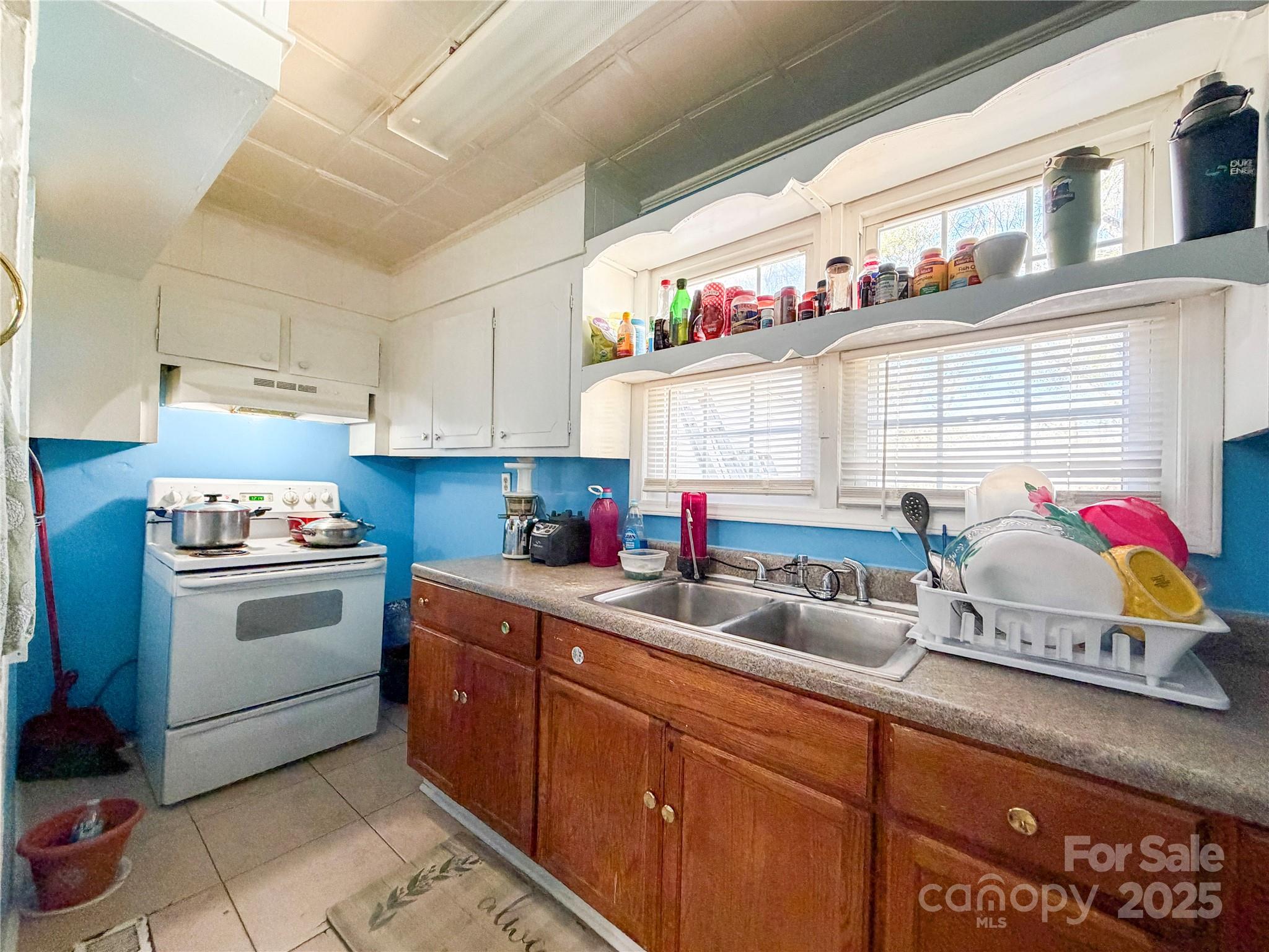 618 Clyde Street Gastonia, NC 28052 - Photo 3 of 8 a kitchen that has a lot of cabinets in it and wooden floors