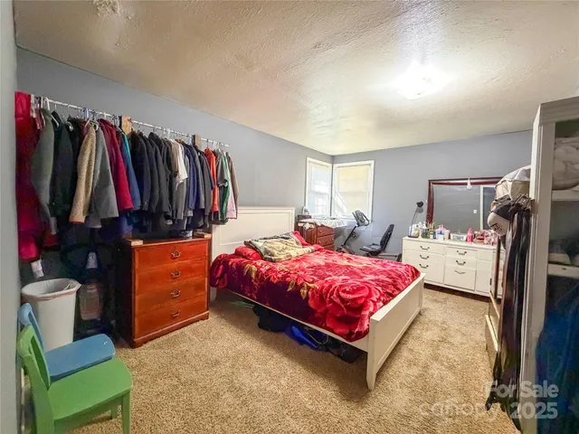 a bed room with a bed and a chair