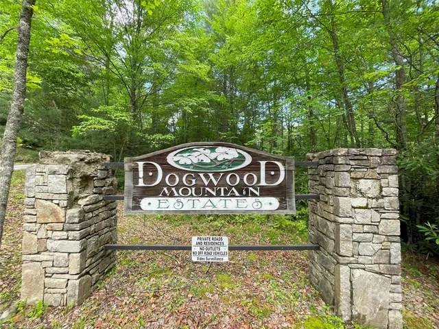 a sign broad in front of a brick building