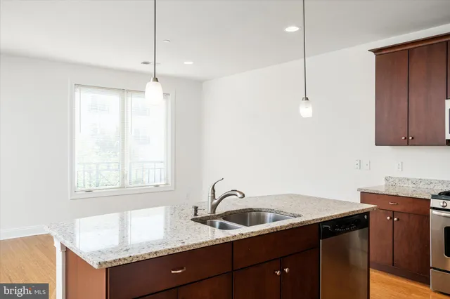 a kitchen with granite countertop a sink cabinets and window