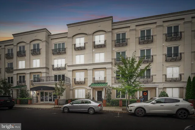 a couple of cars parked in front of a building