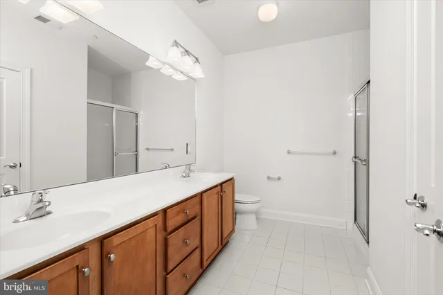 a bathroom with a double vanity sink and mirror