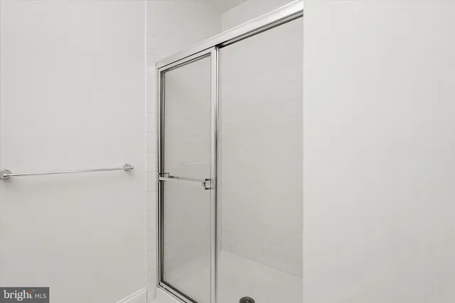 a bathroom with a glass shower door