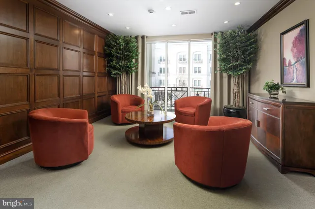 a living room with furniture a large window and a couch