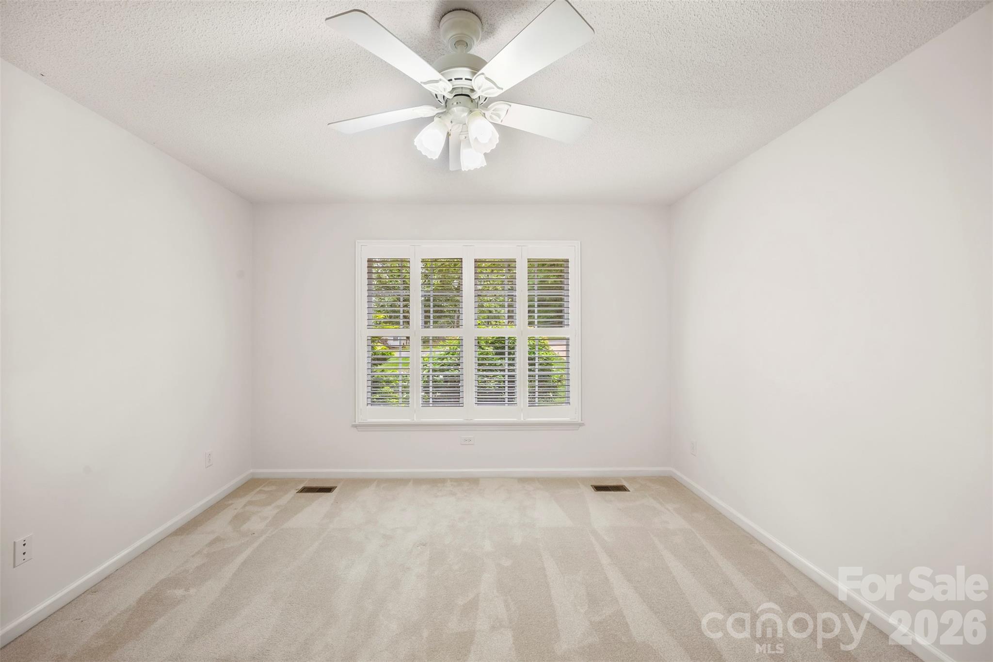 1917 Rucker Road Shelby, NC 28152 - Photo 30 of 41 an empty room with a chandelier fan and windows