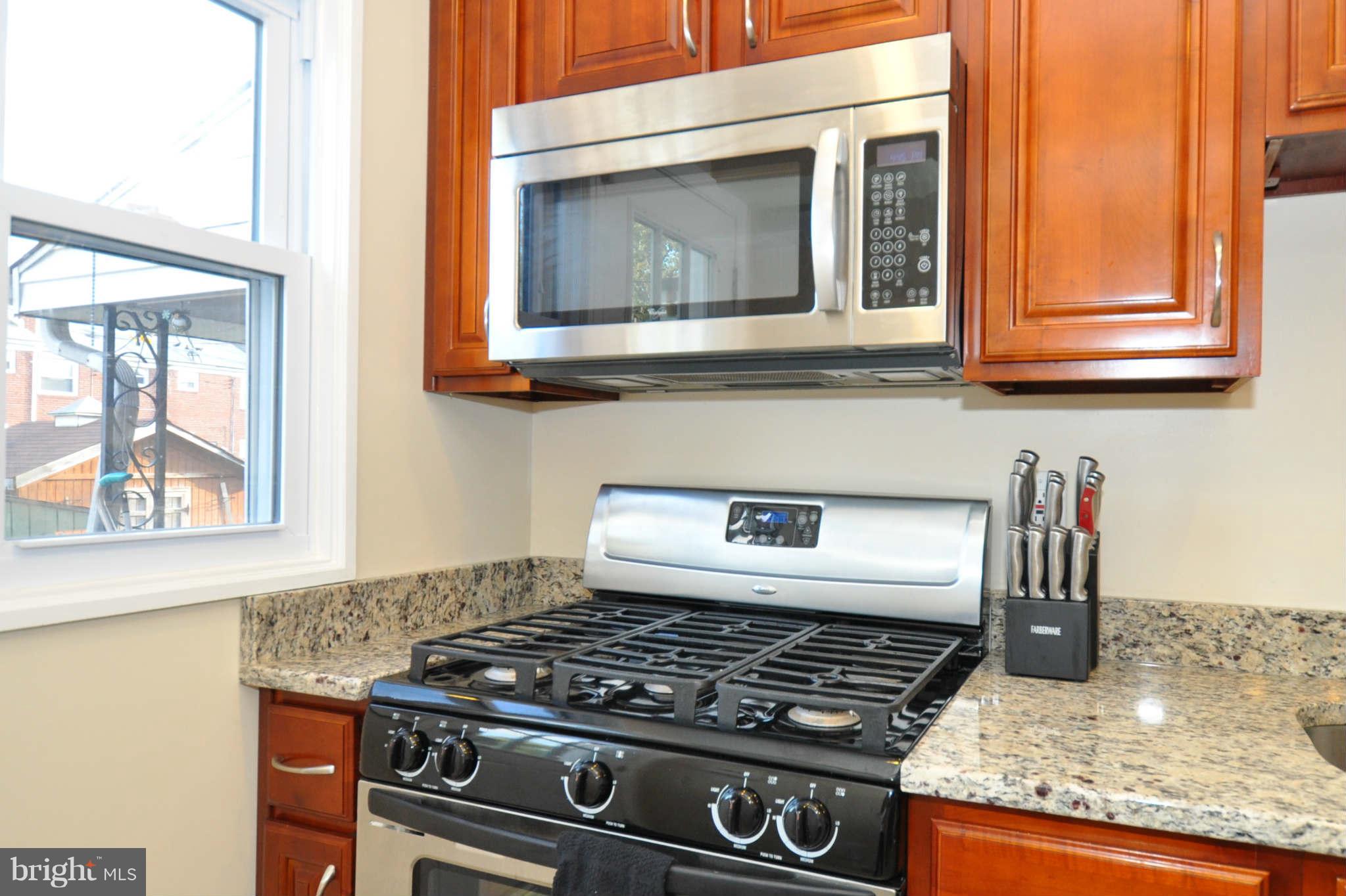 1921 Penhall Road Baltimore, MD 21222 - Photo 13 of 29 a kitchen with granite countertop a stove and a sink