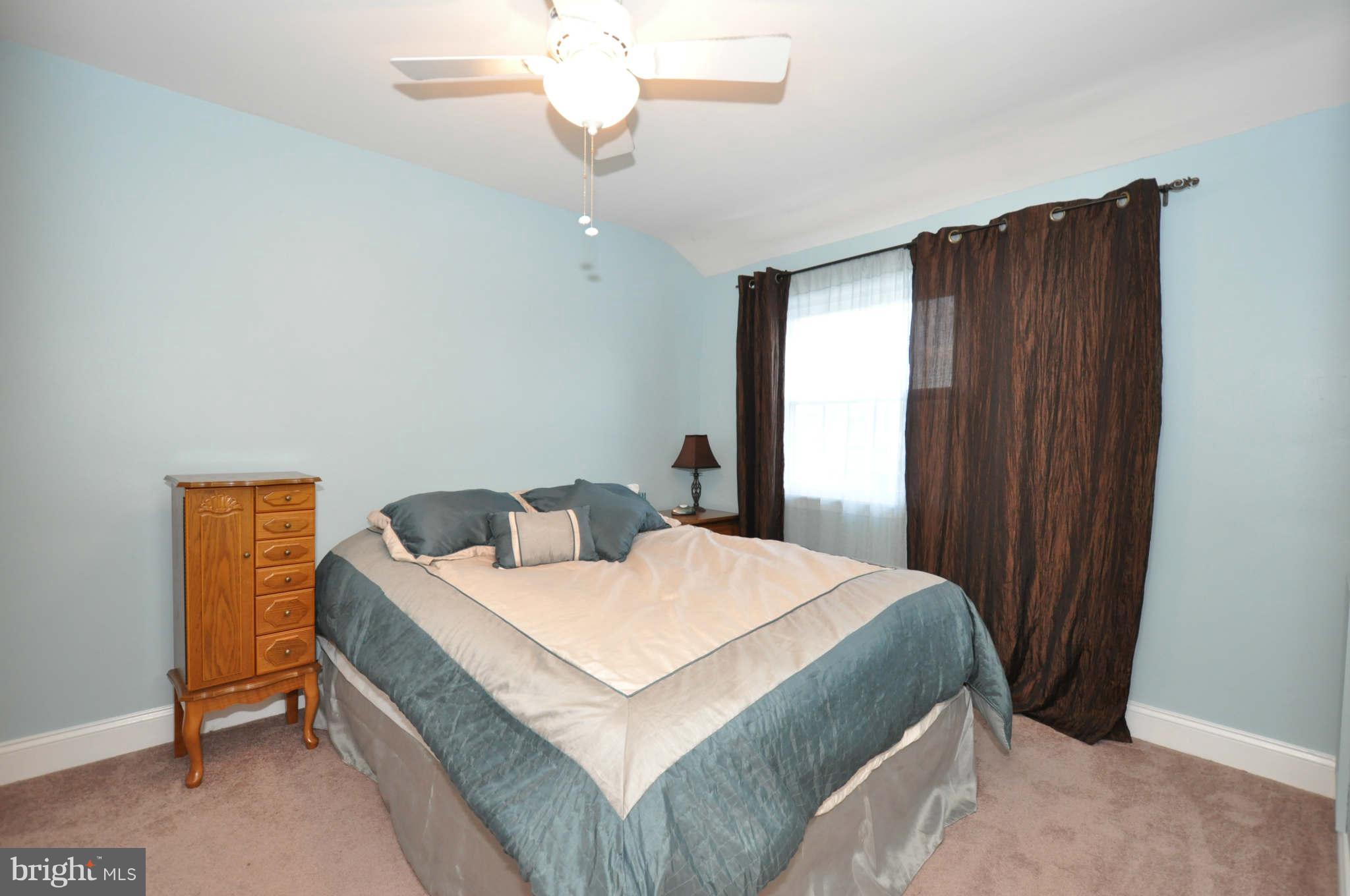 1921 Penhall Road Baltimore, MD 21222 - Photo 17 of 29 a bedroom with a bed and a chandelier
