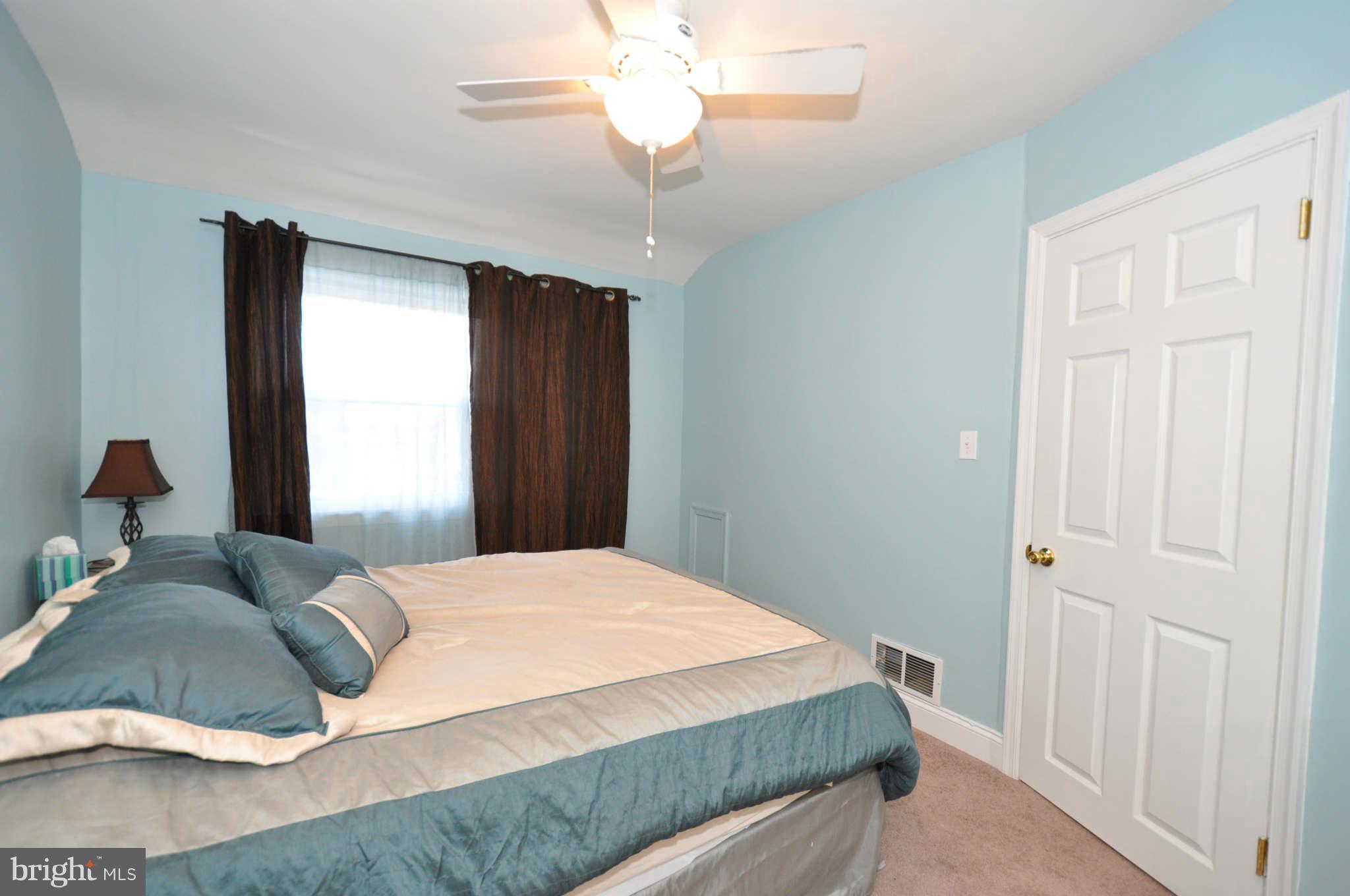 1921 Penhall Road Baltimore, MD 21222 - Photo 18 of 29 a bedroom with a bed and a chandelier