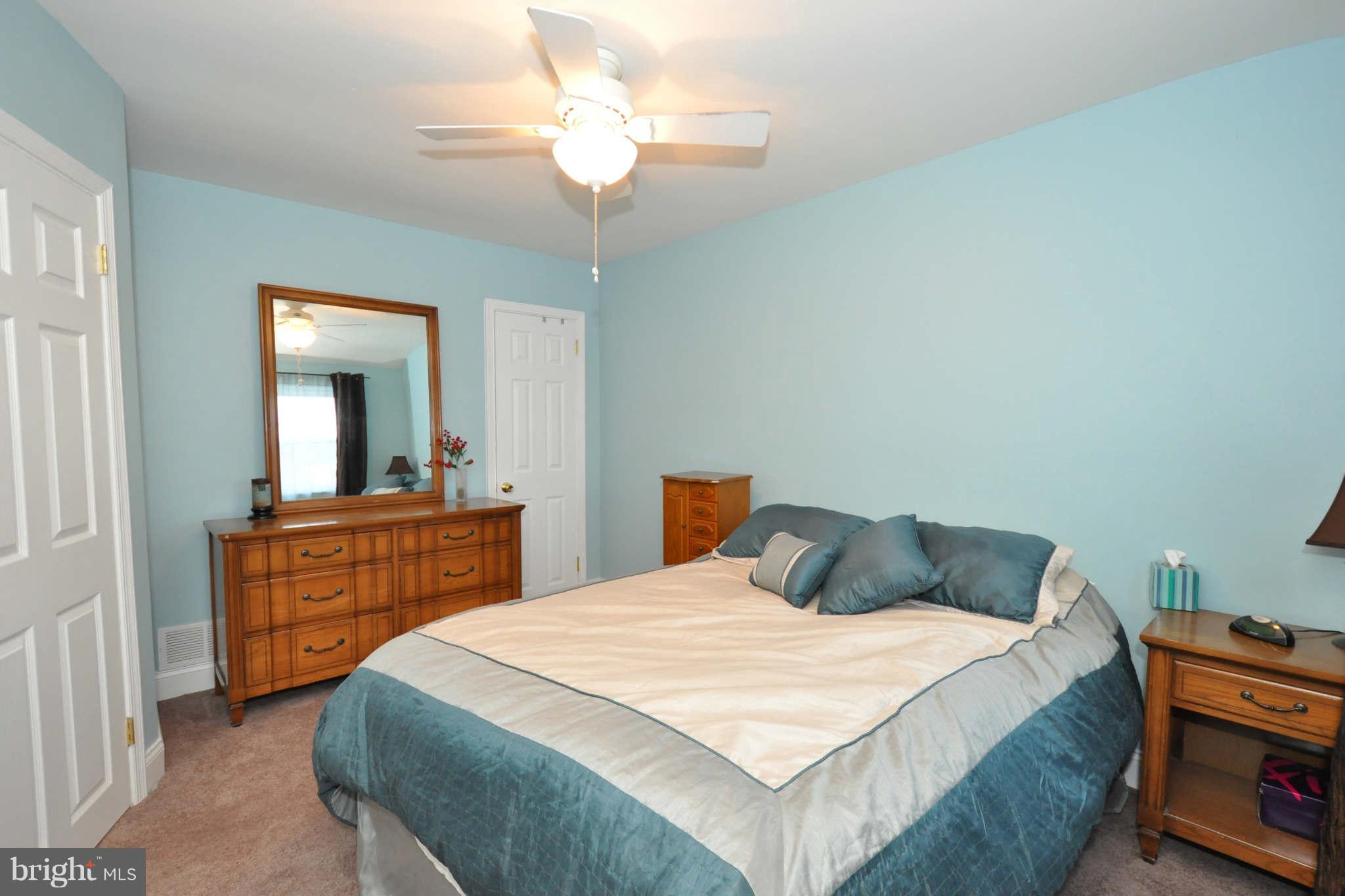 1921 Penhall Road Baltimore, MD 21222 - Photo 19 of 29 a bedroom with a bed and a chandelier