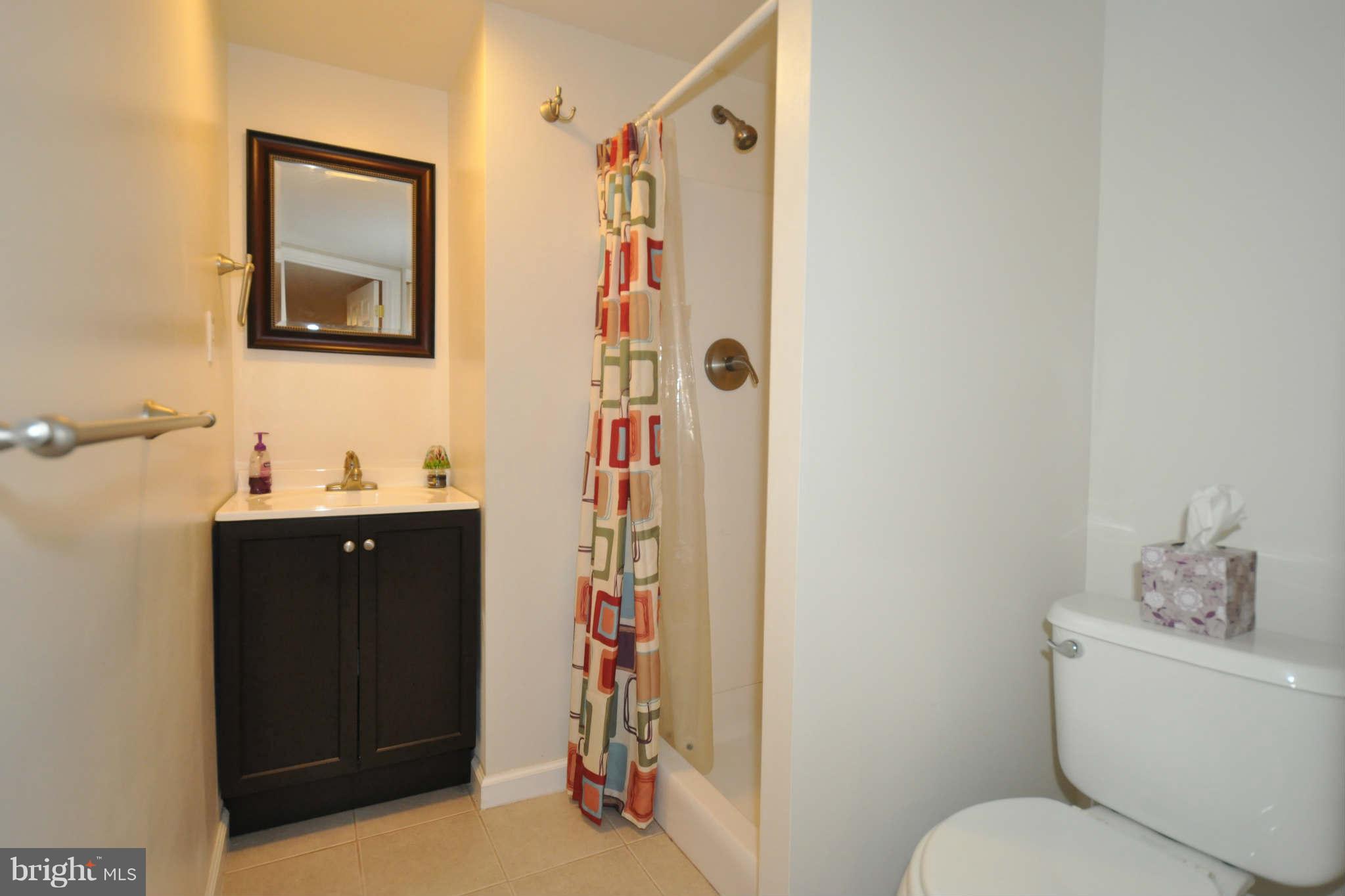 1921 Penhall Road Baltimore, MD 21222 - Photo 25 of 29 a bathroom with a sink toilet and shower