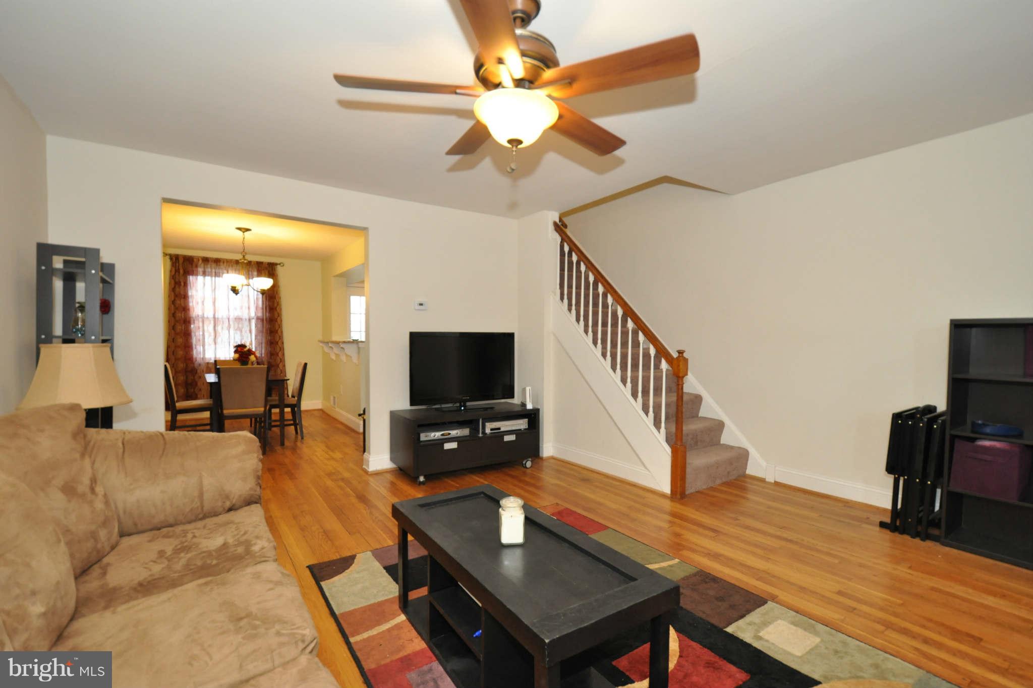 1921 Penhall Road Baltimore, MD 21222 - Photo 6 of 29 a living room with furniture and a flat screen tv with kitchen view