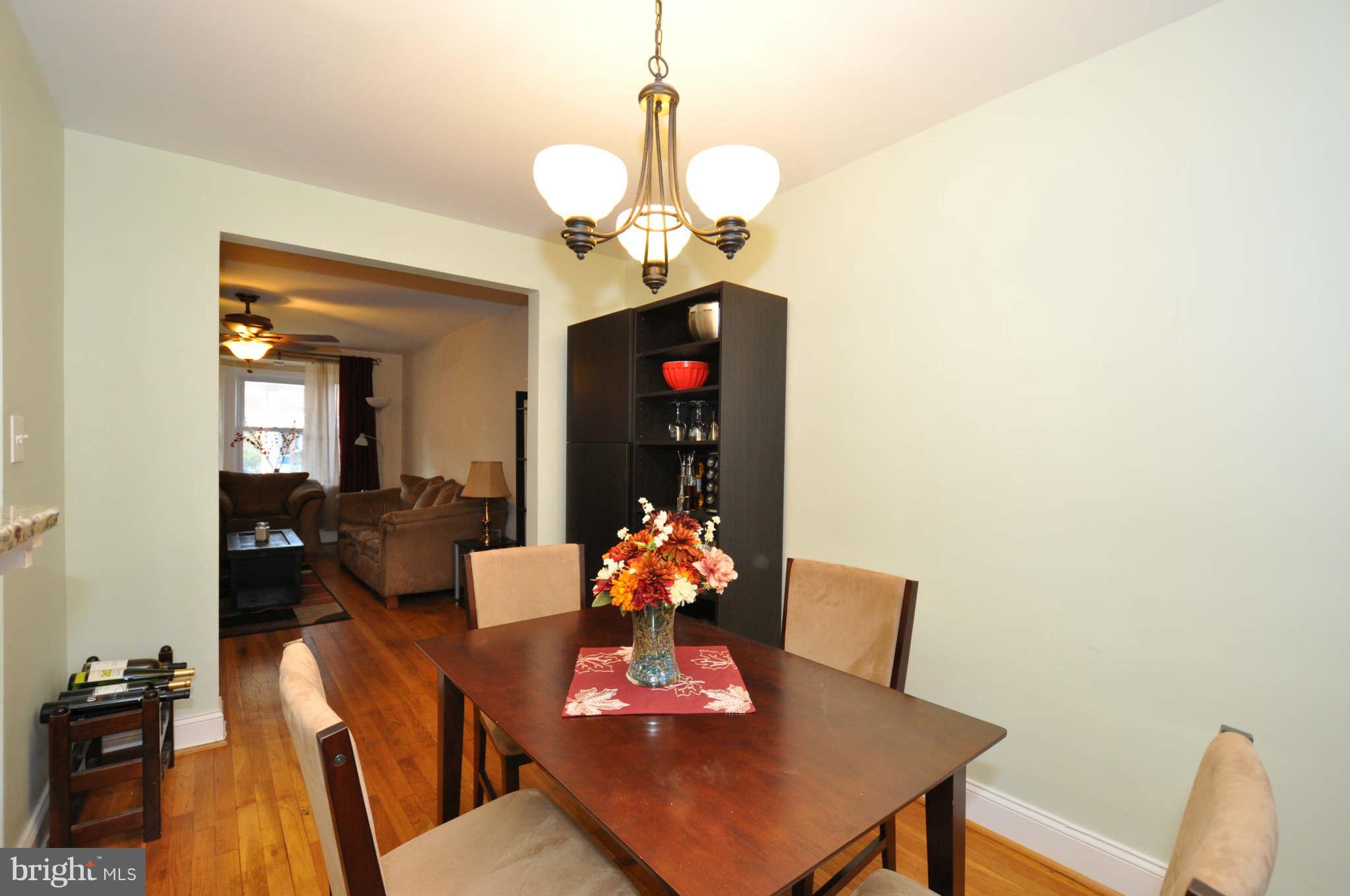 1921 Penhall Road Baltimore, MD 21222 - Photo 10 of 29 a living room with dining table furniture and a chandelier