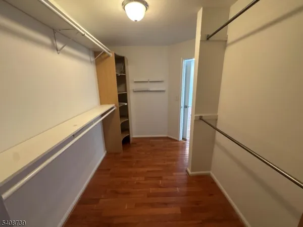 a view of a storage and utility room with refrigerator