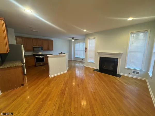 a view of a kitchen with a sink stove cabinets and empty room