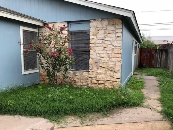 a couple of potted plants in front of door