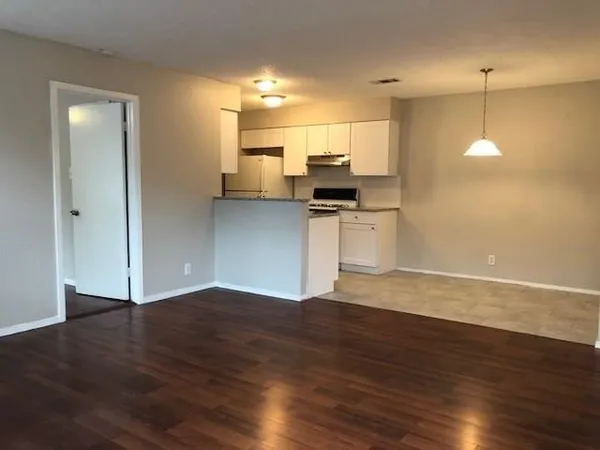 a view of kitchen with wooden floor and electronic appliances
