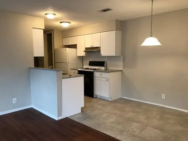 a kitchen with stainless steel appliances a refrigerator and a stove
