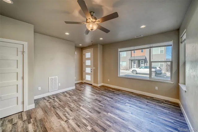 wooden floor in an empty room with a window