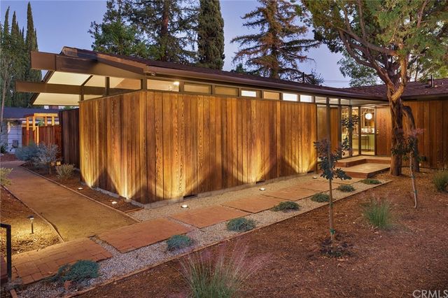a view of a backyard with door and outdoor seating