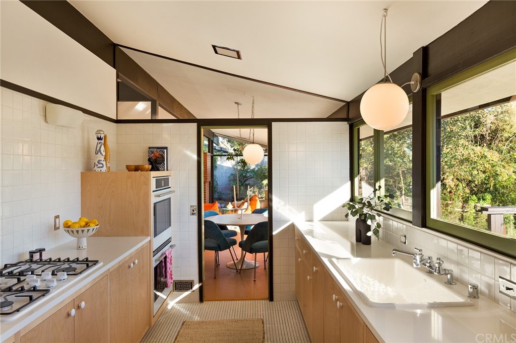 700 Edgeview Drive Sierra Madre, CA 91024 - Photo 12 of 32 a bathroom with a granite countertop sink mirror and a shower