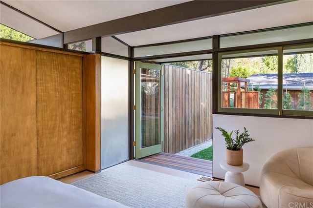 a bedroom with a bed and a potted plant