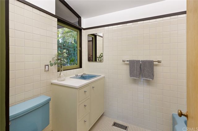 a bedroom with a bed and a potted plant on the wall