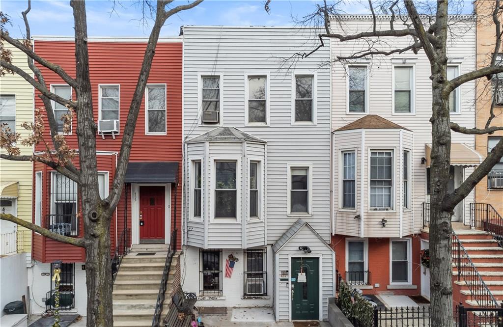 a front view of a residential apartment building with a yard