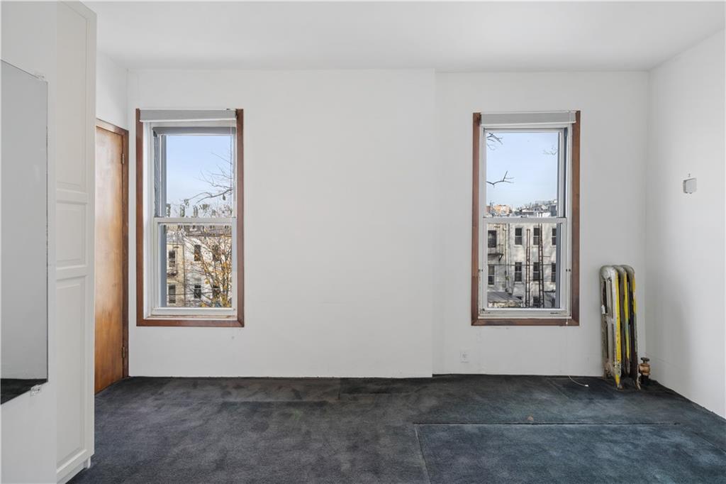 457 44th Street Brooklyn, NY 11220 - Photo 13 of 16 a view of an empty room with a window